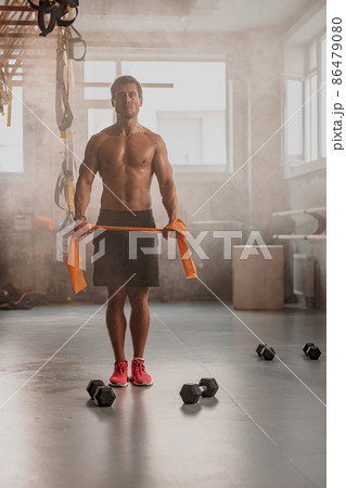 Handsome male personal trainer working in gym 86479080