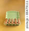 Packaging of chicken eggs on a yellow background in isolation 86479111