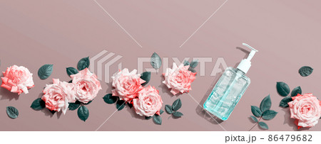 Sanitizer bottle with pink roses overhead view Sanitizer bottle with pink roses overhead view 86479682
