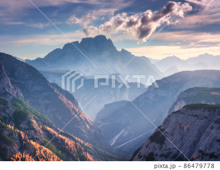 Mountain canyon lighted by bright sunbeams at sunset in autumn in Dolomites, Italy Mountain canyon lighted by bright sunbeams at sunset in autumn in Dolomites, Italy 86479778