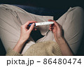 A woman sees a positive pregnancy test result. 86480474