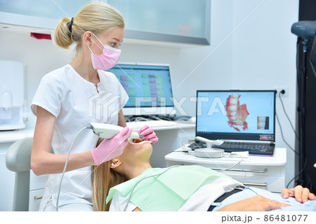 Orthodontist scaning patient with dental intraoral scanner Orthodontist scaning patient with dental intraoral scanner 86481077