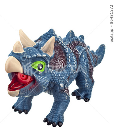 Close up toy dinosaur of bluish color with green eyes, an open mouth and horns on its head, isolated on a white background. Close up toy dinosaur of bluish color with green eyes, an open mouth and horns on its head, isolated on a white background. 86481572