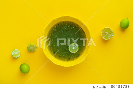 Egyptian Molokhia soup with lime 86481783