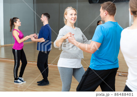 Mature dancing couple during group class Mature dancing couple during group class 86488401