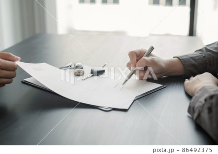 The car dealer provides advice on loans, insurance details, and car rental information, and delivers the car with the keys after the rental contract is signed 86492375