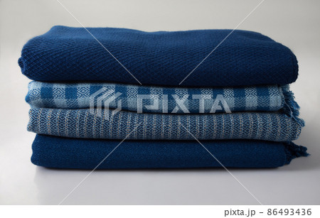 stack of hand woven shawls, Thai cotton indigo dyed stack of hand woven shawls, Thai cotton indigo dyed 86493436