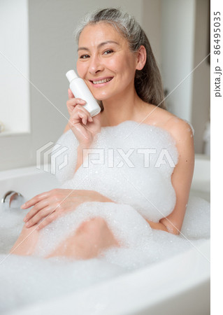 Female holding natural skincare or body care cosmetic 86495035