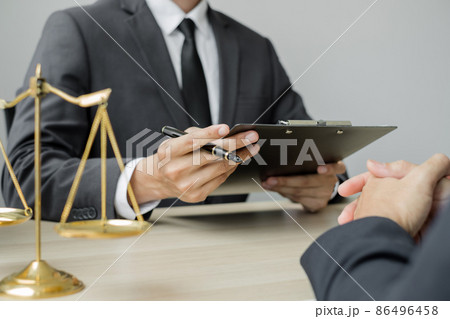 A male lawyer or a judge counseling clients about judicial justice and prosecution with scales, judges gavel, legal documents legal services concept A male lawyer or a judge counseling clients about judicial justice and prosecution with scales, judges gavel, legal documents legal services concept 86496458