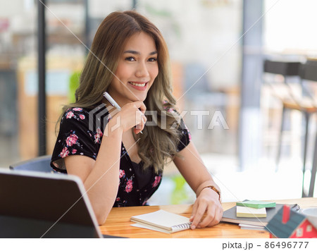 College student doing her homework assignment in a coffee shop College student doing her homework assignment in a coffee shop 86496777