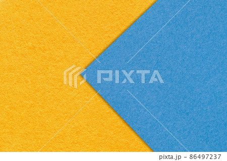 Texture of orange and blue paper background, half two colors, macro. Yellow and sky trendy palette. 86497237