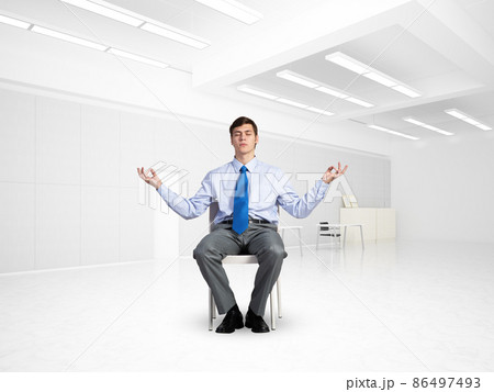 young businessman meditating in the office young businessman meditating in the office 86497493