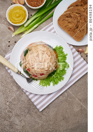 Delicious chicken aspic on a plate on concrete table 86498194