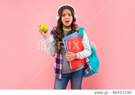 listen to music. new technology. childhood development. child in earphones hold workbook listen to music. new technology. childhood development. child in earphones hold workbook 86501290