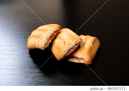 Three square biscuit cookies on wooden table Three square biscuit cookies on wooden table 86501521