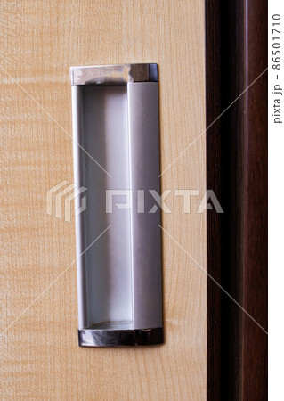 The door handle of wooden wardrobe closeup 86501710