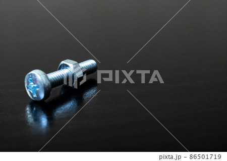 Bolt and nut on a wooden background Bolt and nut on a wooden background 86501719