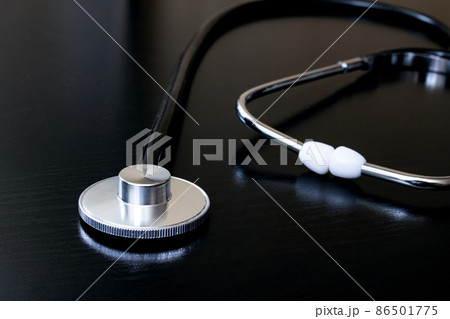 Medical stethoscope on a black table closeup 86501775