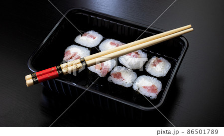 Japanese rolls and sticks on wooden table Japanese rolls and sticks on wooden table 86501789
