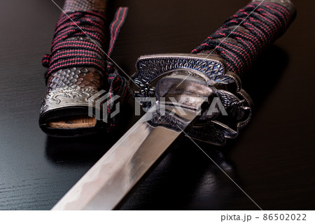 Samurai sword on a black wooden table 86502022