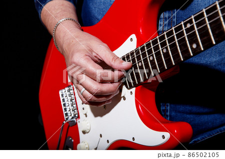 man plays the electric guitar 86502105