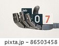 robots hand holds cubes with the date February 07. close-up, selective focus. World Robotics Day 86503458