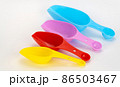 spatulas for cereals and spices on a white background. set of colored scoops for bulk products 86503467