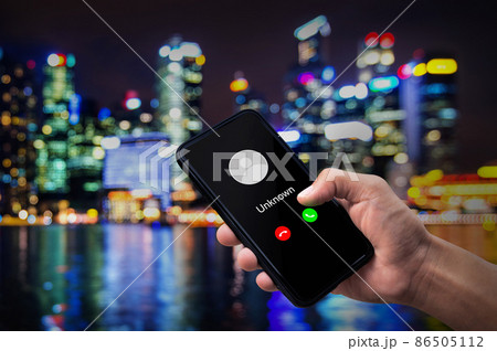 Phone call from unknown number. Man getting a call on phone from an unknown number. 86505112