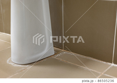 Traces of a pipe leak near the sink in the bathroom Traces of a pipe leak near the sink in the bathroom 86505236