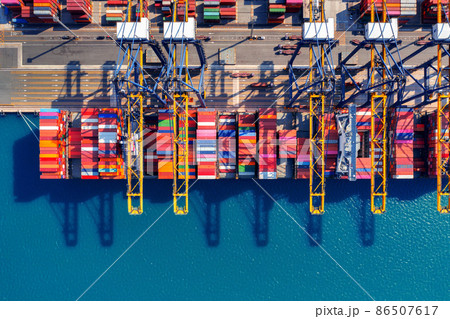 Aerial view of cargo ship and cargo container in harbor. Aerial view of cargo ship and cargo container in harbor. 86507617