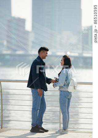 Positive Couple Standing on Bridge Positive Couple Standing on Bridge 86510595