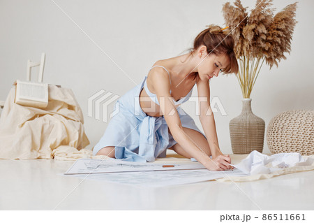 beautiful sexy woman working with blueprints at home 86511661