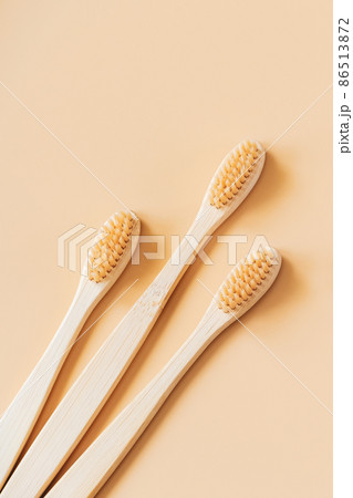 Eco-friendly wooden toothbrushes on trendy beige background. Dental care concept. Happy dentist day. Greeting card. Eco-friendly wooden toothbrushes on trendy beige background. Dental care concept. Happy dentist day. Greeting card. 86513872