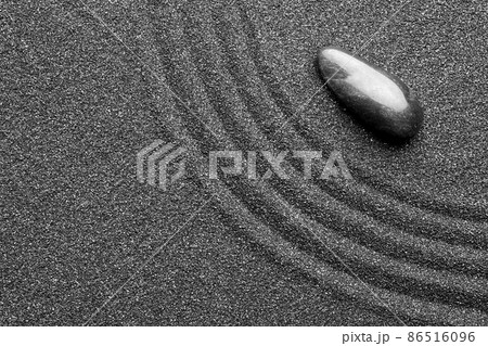 Zen garden stone on black sand with pattern, top view 86516096