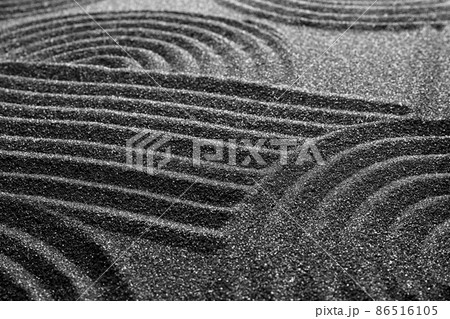Pattern on decorative black sand, closeup. Zen and harmony 86516105