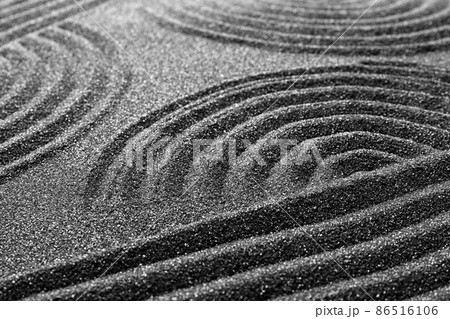 Pattern on decorative black sand, closeup. Zen and harmony 86516106