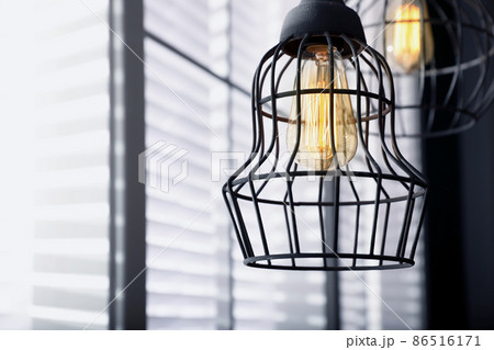 Stylish metallic pendant lamp with Edison light bulb indoors Stylish metallic pendant lamp with Edison light bulb indoors 86516171
