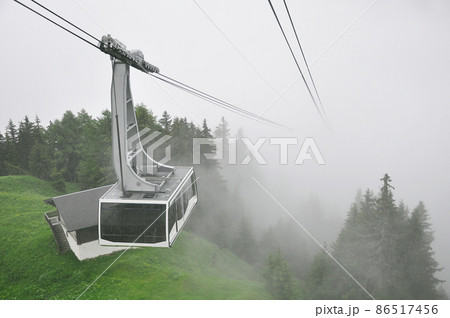 Cableway of the ski resort at foggy day time. Cableway of the ski resort at foggy day time. 86517456