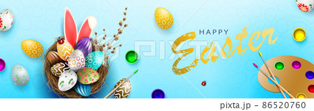Blue composition with Easter eggs in the nest, rabbit ears, palette with paints 86520760