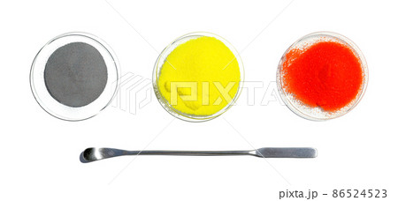 Zinc Powder, Potassium Chromate and Potassium Dichromate in chemical watch glass placed next to the stainless spatula. Closeup chemical ingredient on white laboratory table. Top View 86524523