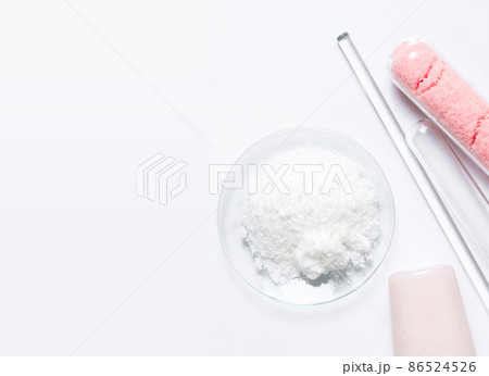 Beauty care cream, himalayan pink salt and Polyacrylic acid powder placed next to Stirring Rod and Test tube. Chemicals for beauty care on white laboratory table. (Top View) 86524526