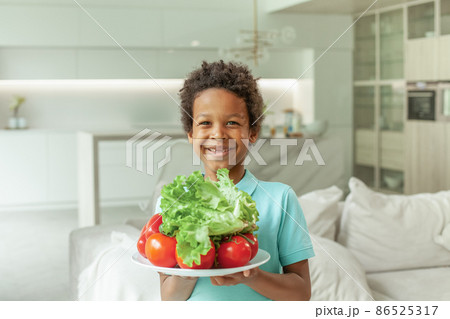 Happy healthy child boy with fresh vegetables portrait Happy healthy child boy with fresh vegetables portrait 86525317