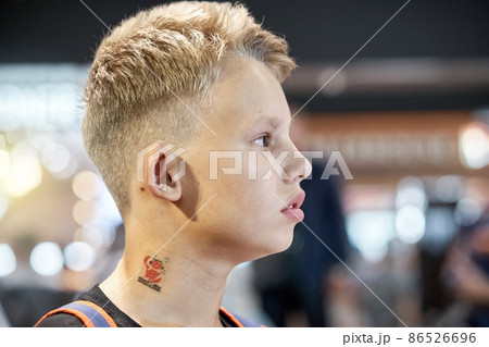 Blond-haired teenage boy sits in waiting room of airport Blond-haired teenage boy sits in waiting room of airport 86526696
