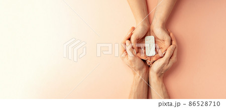 Pregnancy test kit. Female hand hold positive pregnant test with silk ribbon on pink banner background. Medical healthcare gynecological, pregnancy fertility maternity people concept. 86528710