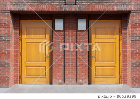 Modern entrance to the house, twin wooden doors. Modern entrance to the house, twin wooden doors. 86529399