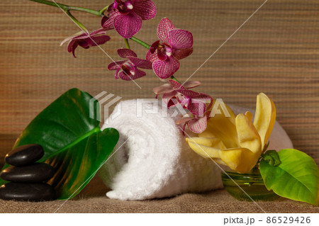Beauty treatment and wellness background with massage bubbles, magnolia, orchid flower, towels. Spa background 86529426