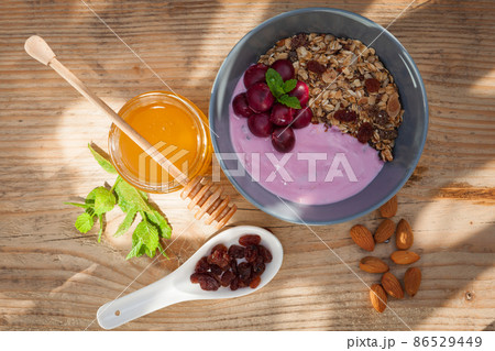 Morning meal in a bowl on a wooden table Morning meal in a bowl on a wooden table 86529449