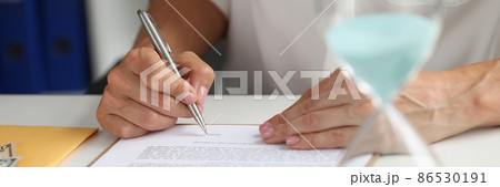 Female hand puts signature in contract at workplace Female hand puts signature in contract at workplace 86530191