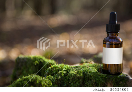 Essential oil for beard or aromatherapy in glass bottle and man with. Essential oil for beard or aromatherapy in glass bottle and man with. 86534302