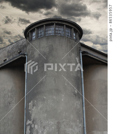 Historic prison wall with a watchtower - cloudy sky. Historic prison wall with a watchtower - cloudy sky. 86535957